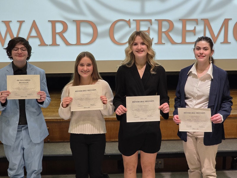 Hour high school students hold certificates.