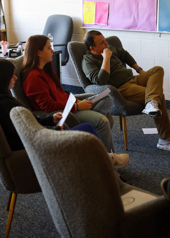 teacher and student sitting in chairs