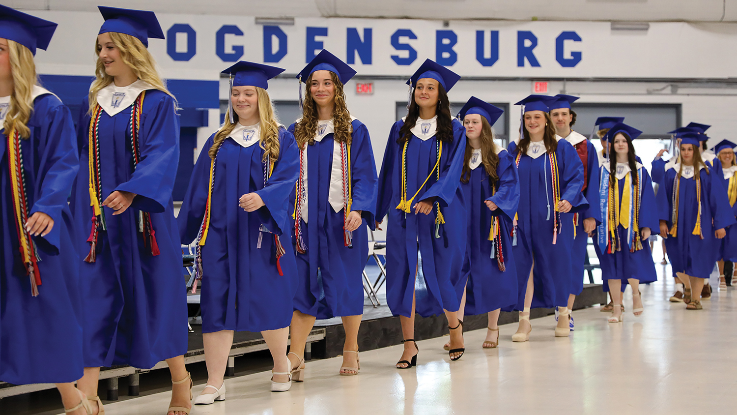 Graduates walk in a line during the graduation ceremony.