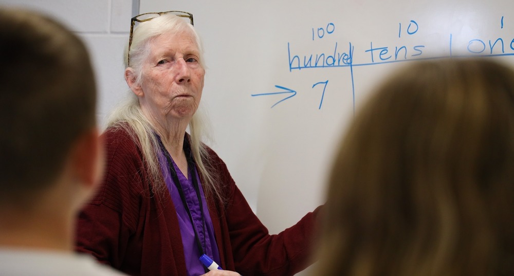 Judy Green doing math problems with students