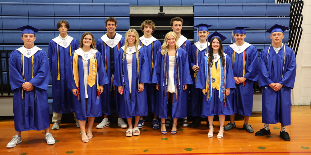 Ashtyn Amo, Chloe Best, Bryan Doser, Tegan Frederick, Ty Jacobs, Mia Jeneault, Gabriella Ott, Gabe Peabody, Nicholi Ramsdell, Lorenzo Rand, Tyler Sovie, Austin Thornhill and Zoee Williams in graduation caps and gowns