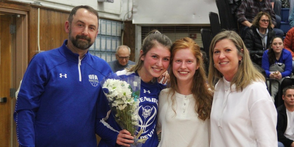 Mark Henry and family take group photo at senior game
