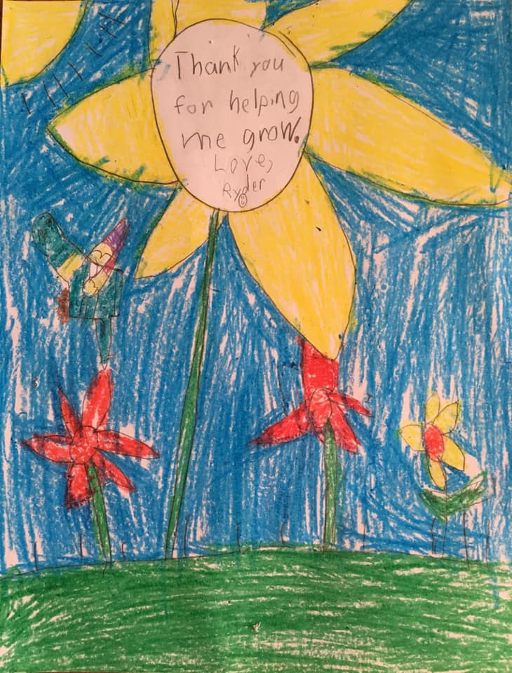 A child's crayon drawing of a flower with the words "thank you for helping me grow".