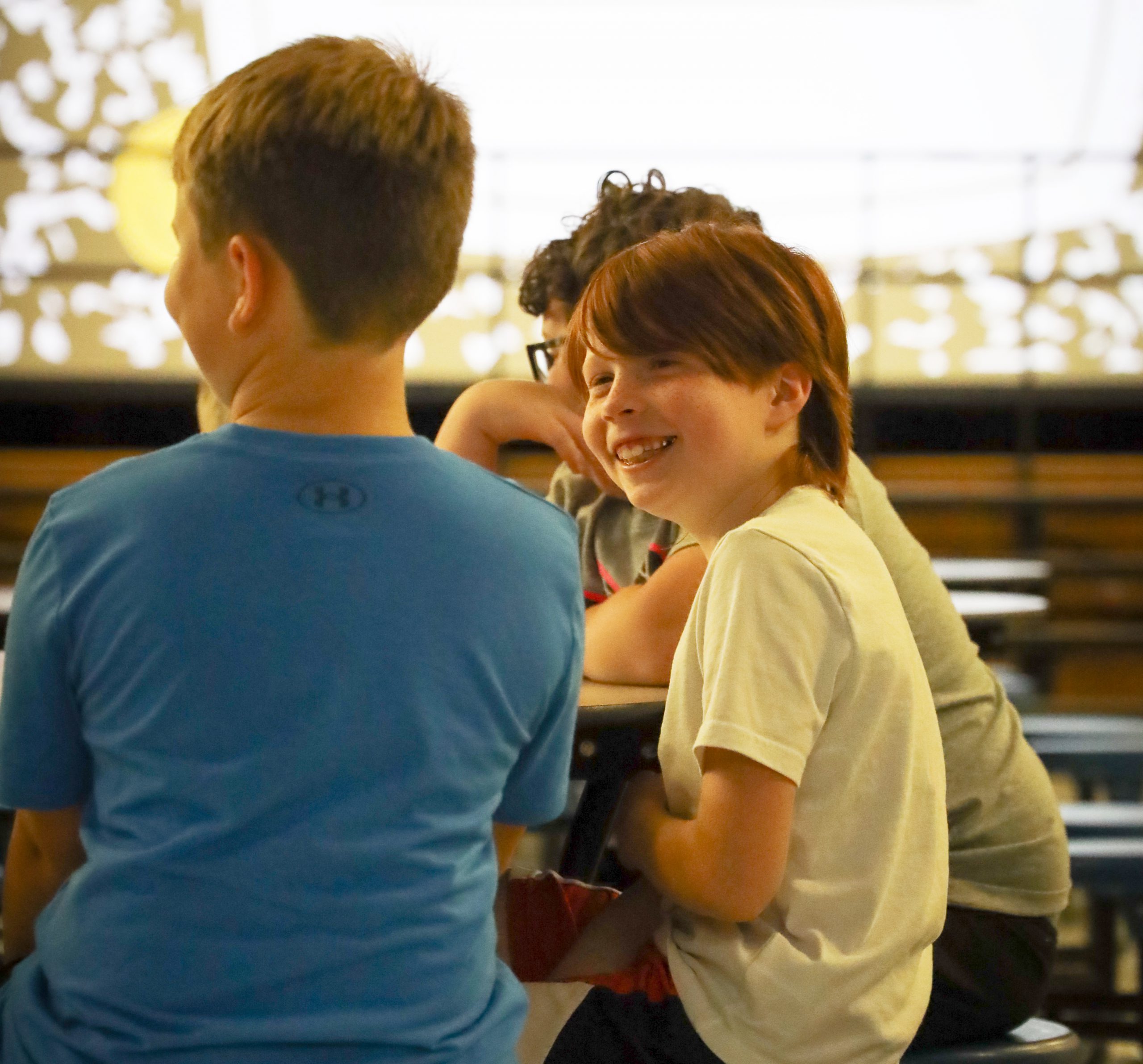A JFK student laughs with friends.