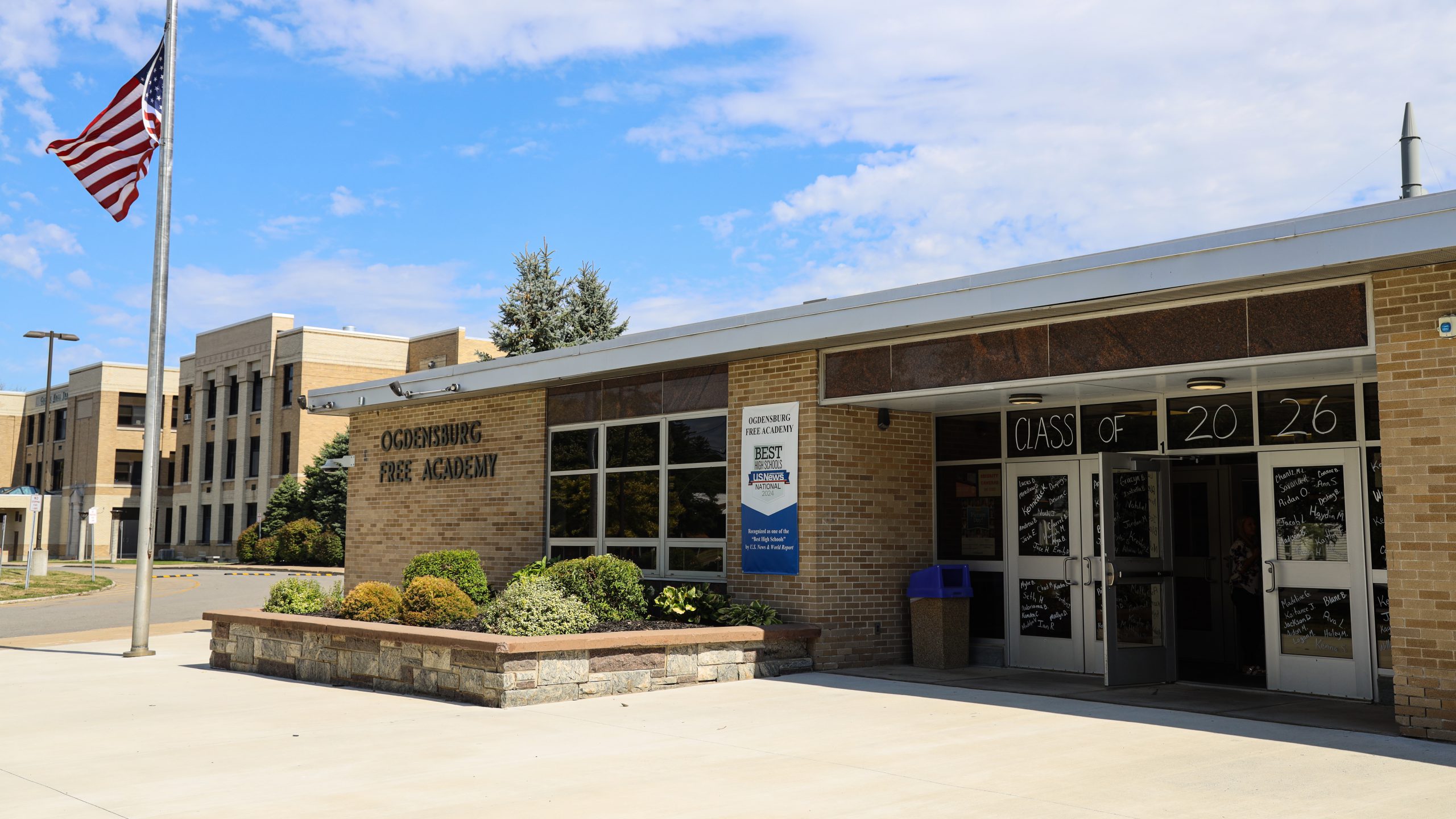 Exterior of the OFA building, which "class of 2026" written in chalk on the windows.