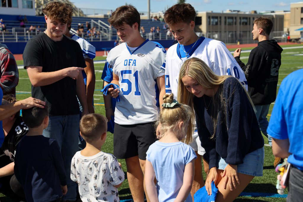 Four OFA students interact with kindergarteners.