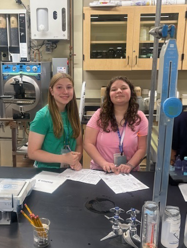 Two OFA students work in a lab setting.