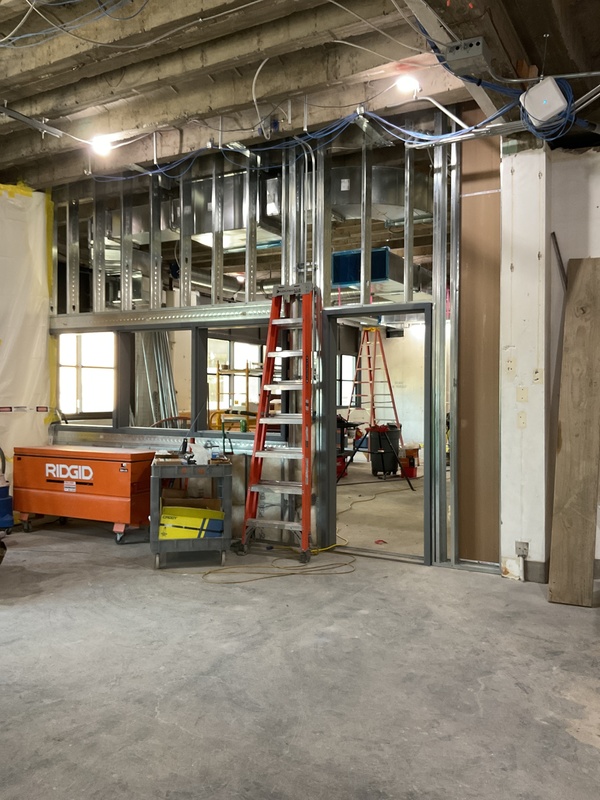 An interior construction space with metal studs and concreate floor.