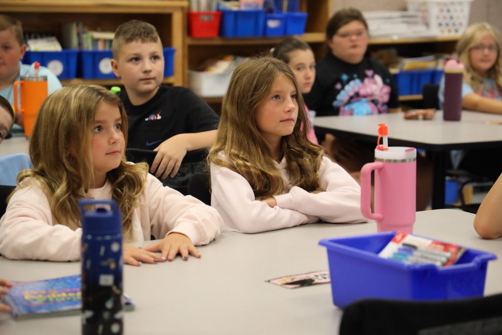 Students being attentive in a classroom setting.