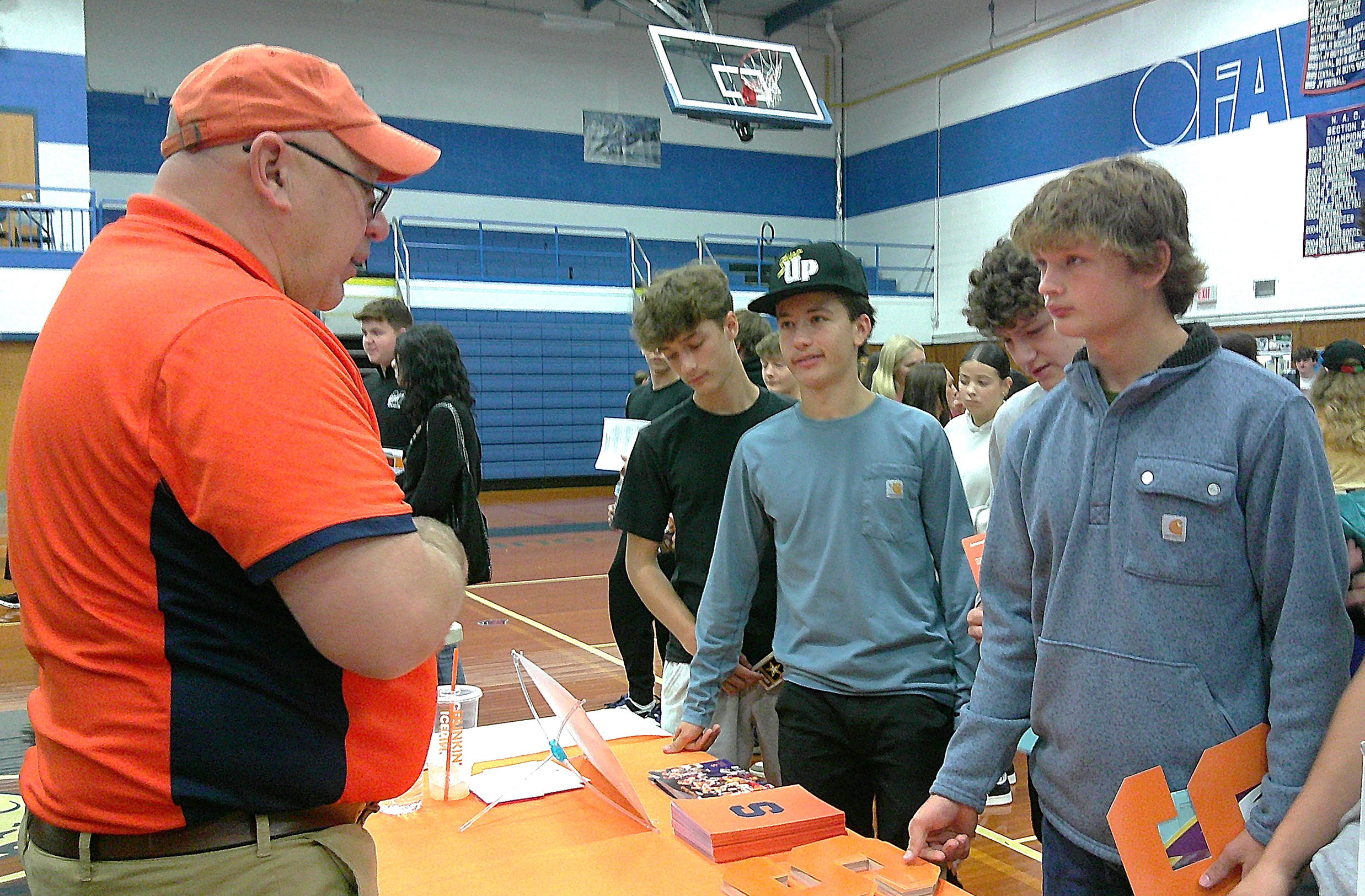 OFA students speak with a representative from Syracuse University.