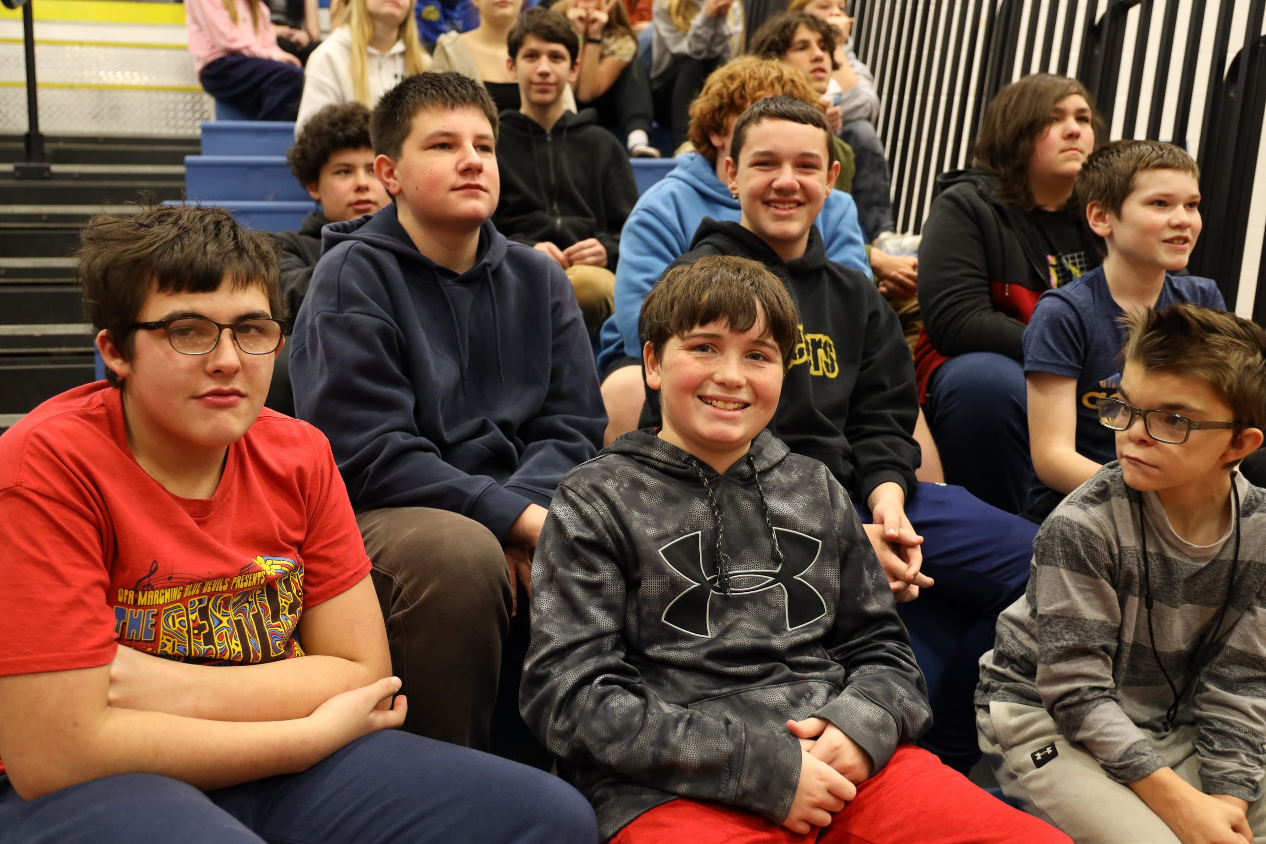 Students sitting on the bleachers in the gym