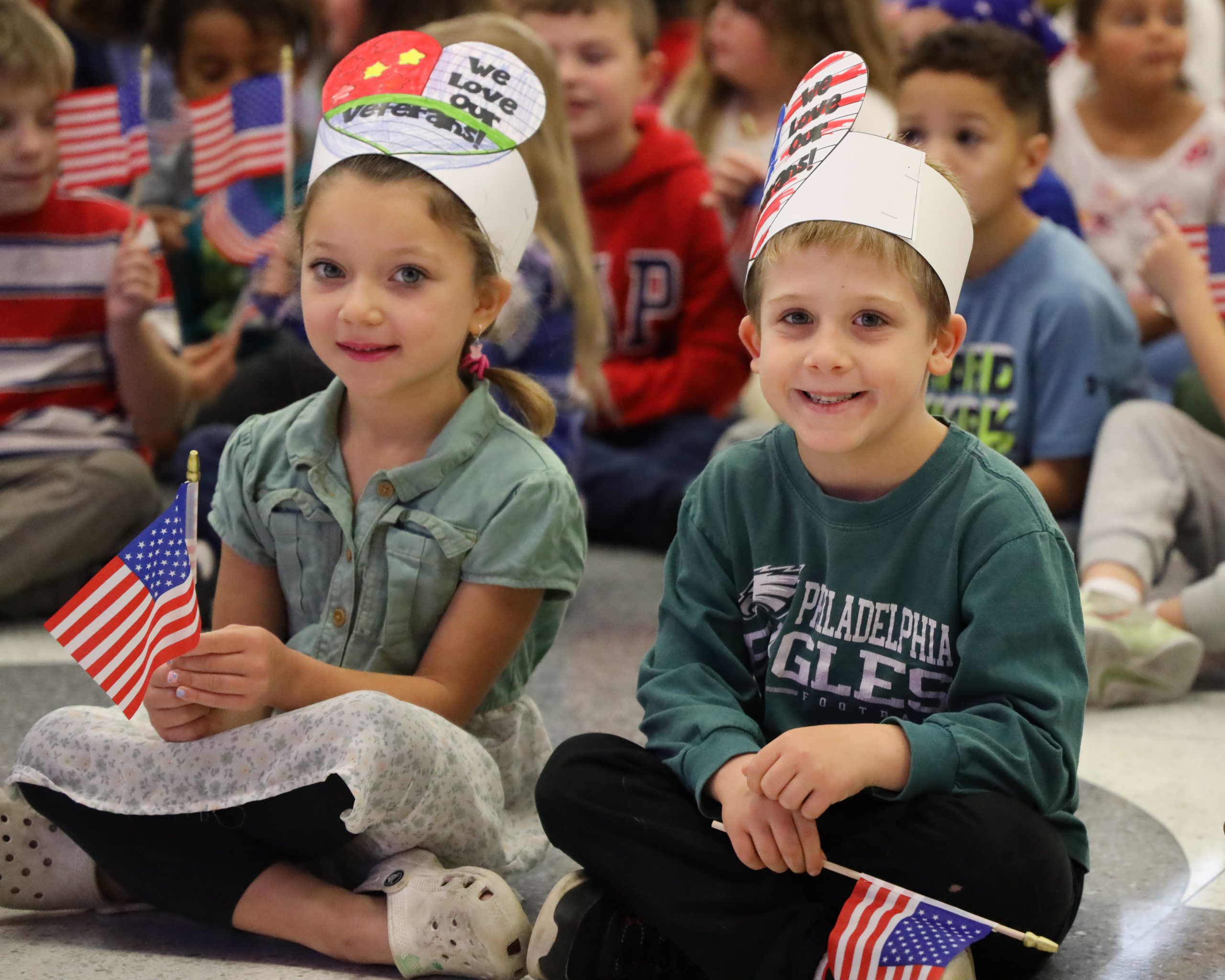 Two students posing during veterans day ceremony