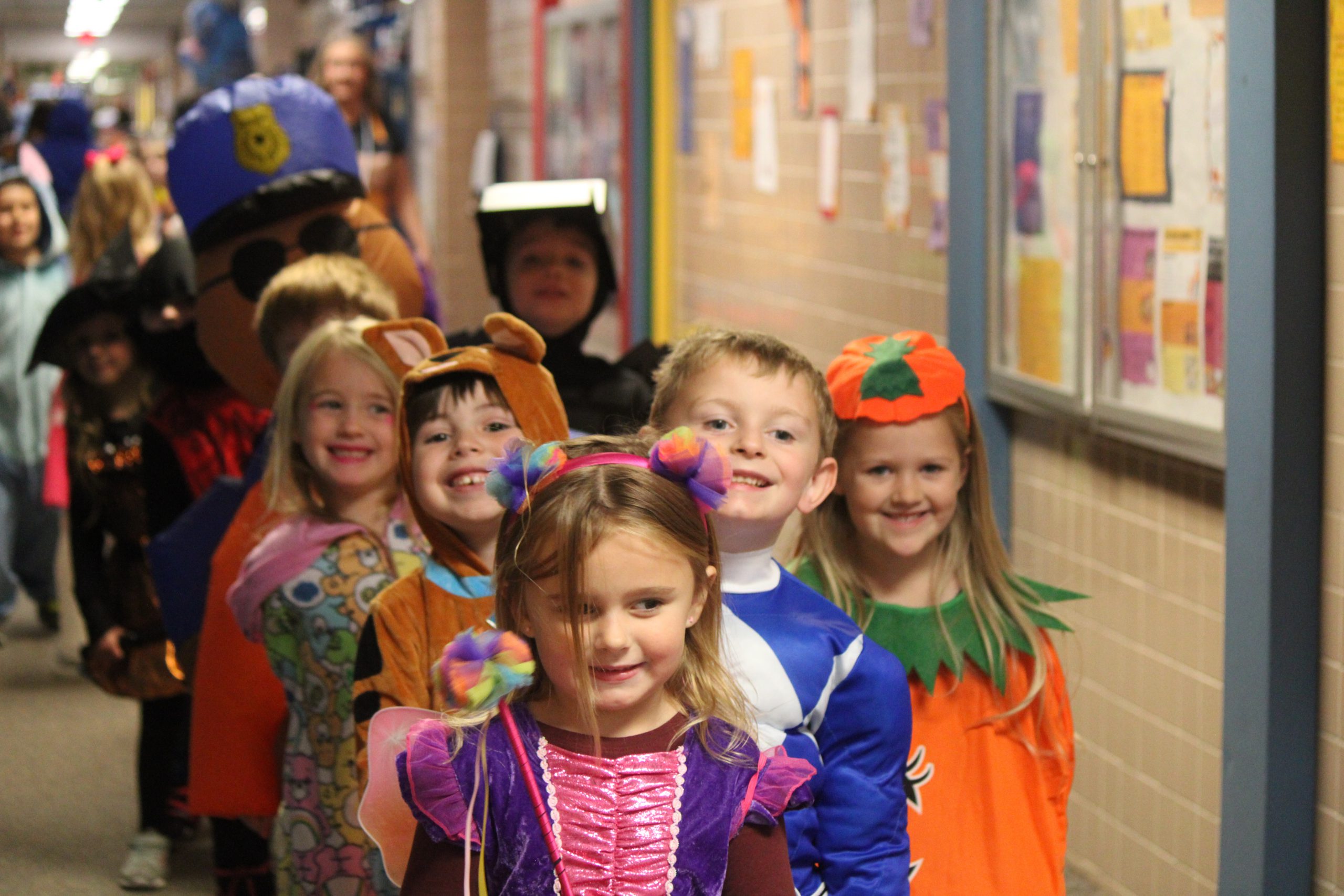 Group of elementary students walking the hallways during Halloween parade