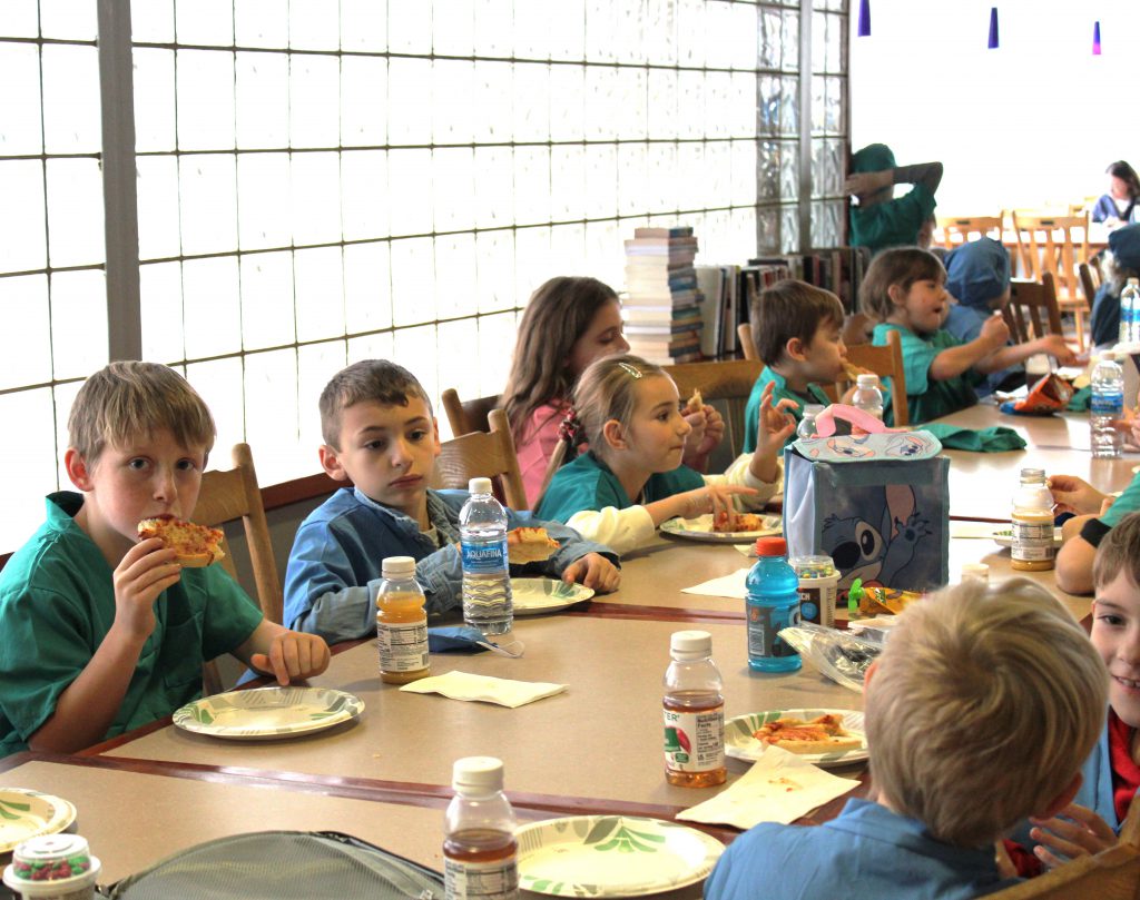 Group of elementary students eating lunch