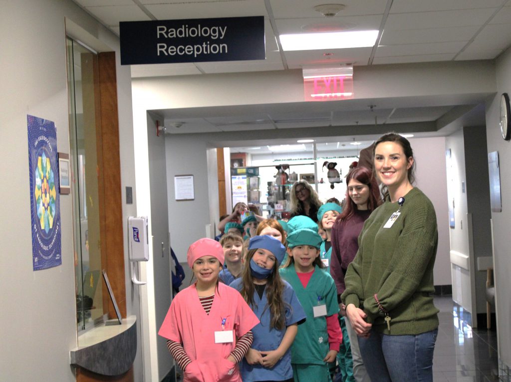 Group of elementary students lined up with hospital staff