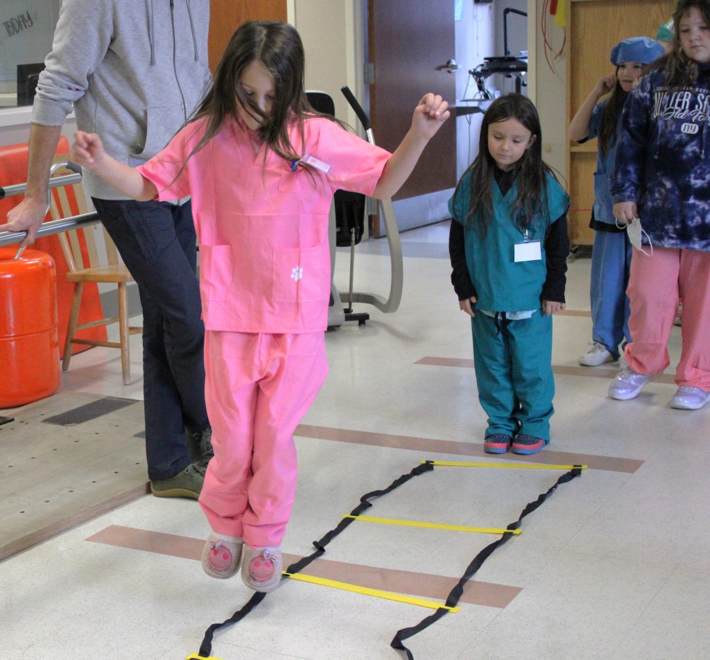 Female elementary student participates in jumping activity