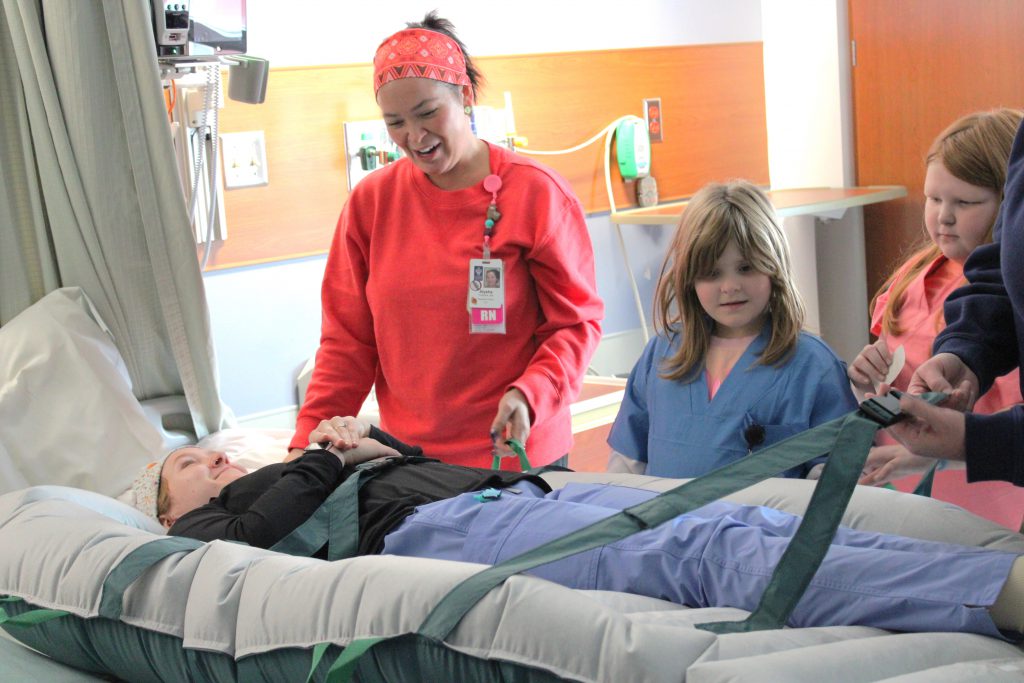 Elementary students with hospital staff members
