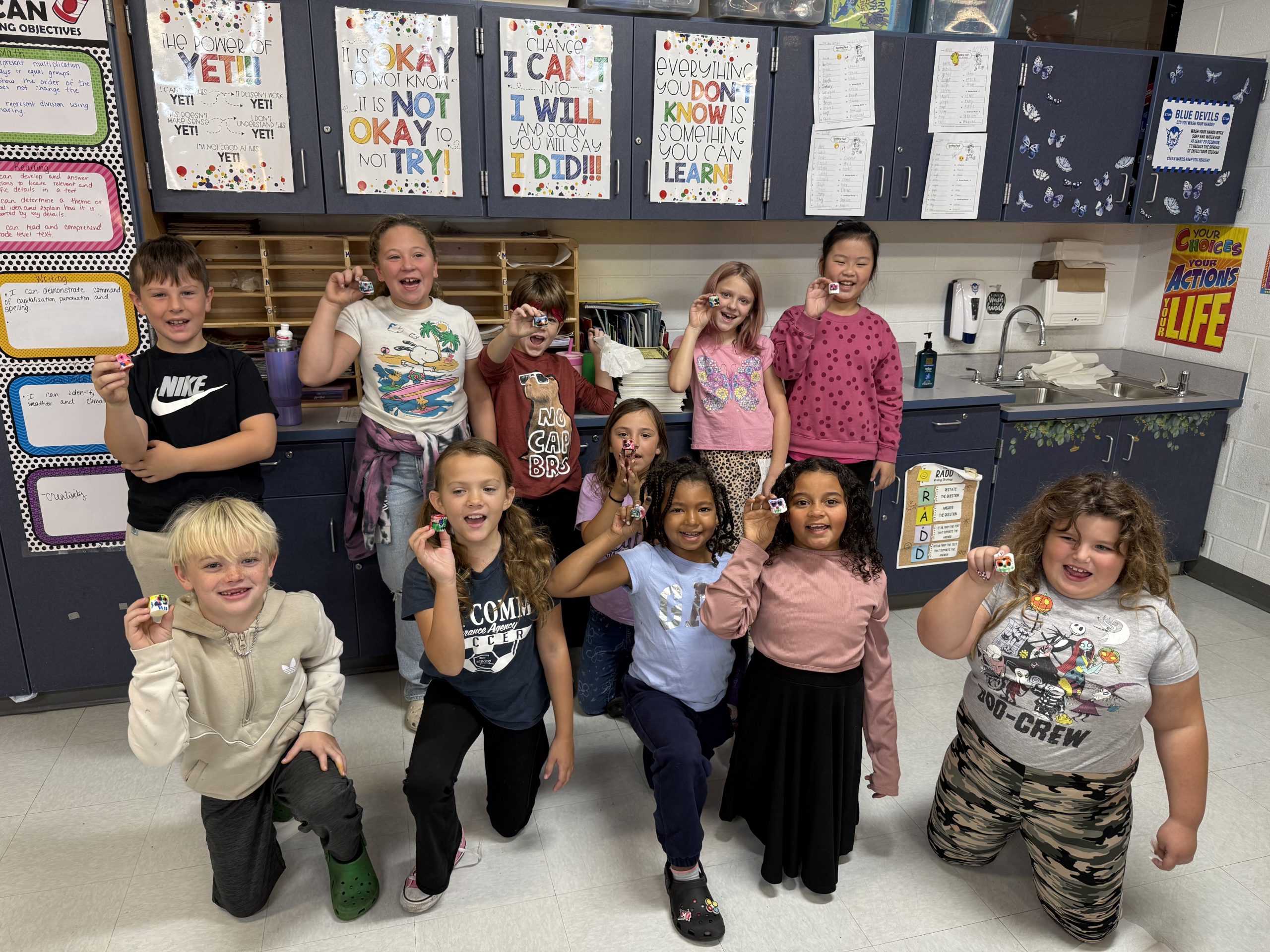 Group of elementary students holding objects