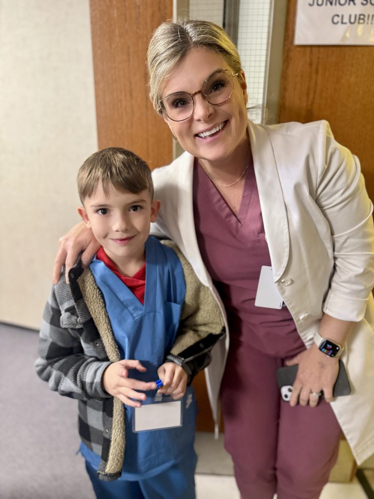 Male elementary student with female hospital staff member