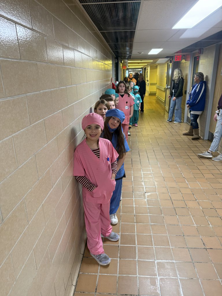 Elementary students lined up in the hallway at the hospital