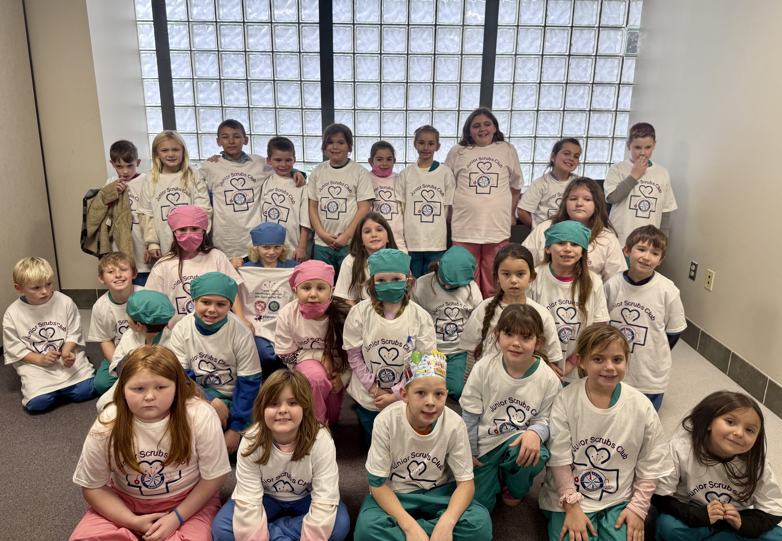 Group of elementary students wearing t-shirts from hospital programming