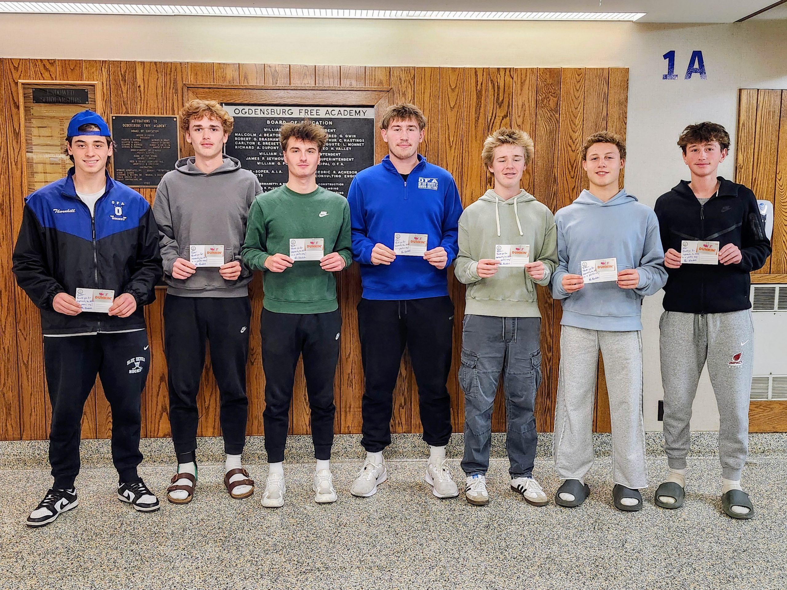 High school students holding notecards