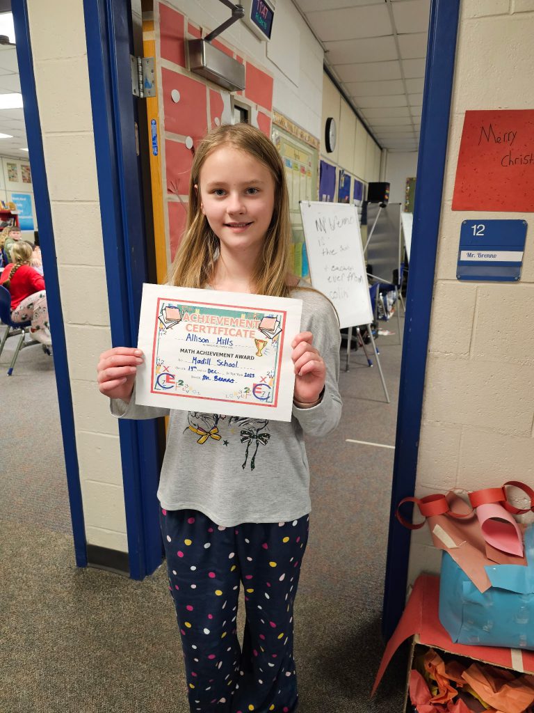 Female elementary student holding a certificate