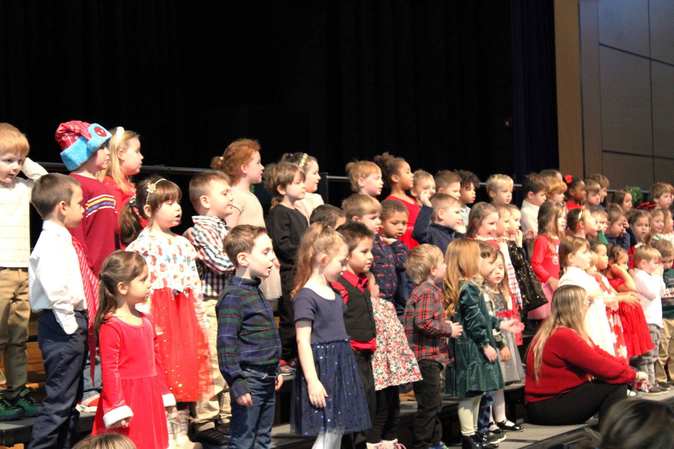 Large group of elementary students performing on risers