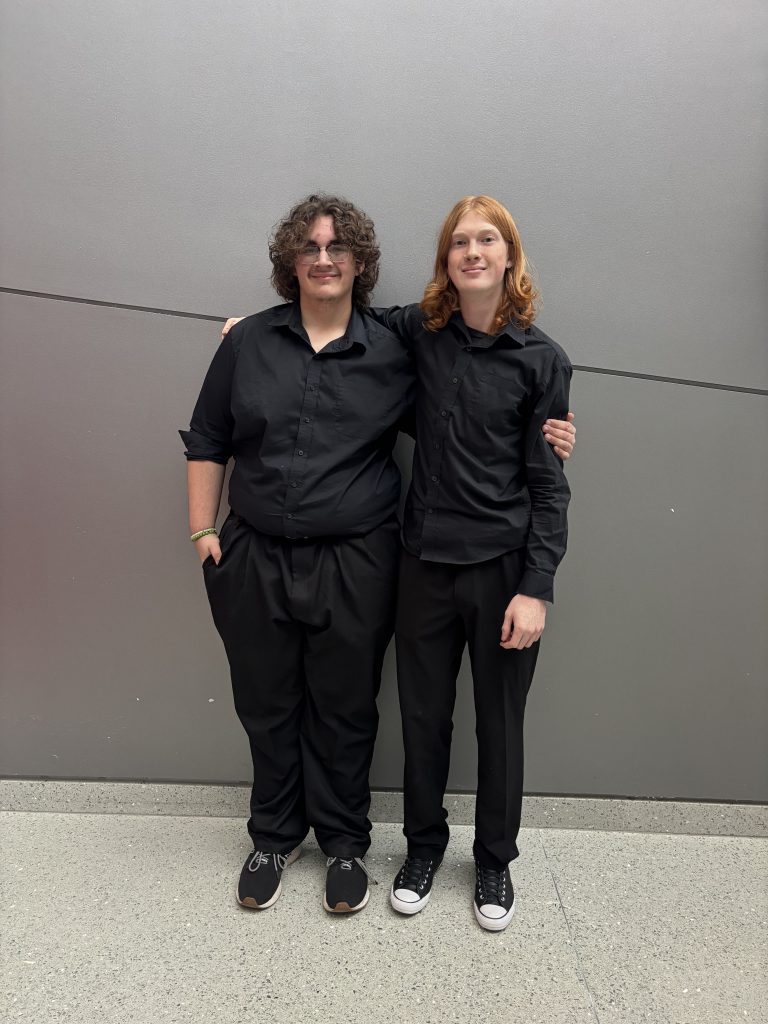 Two male teenage students smiling