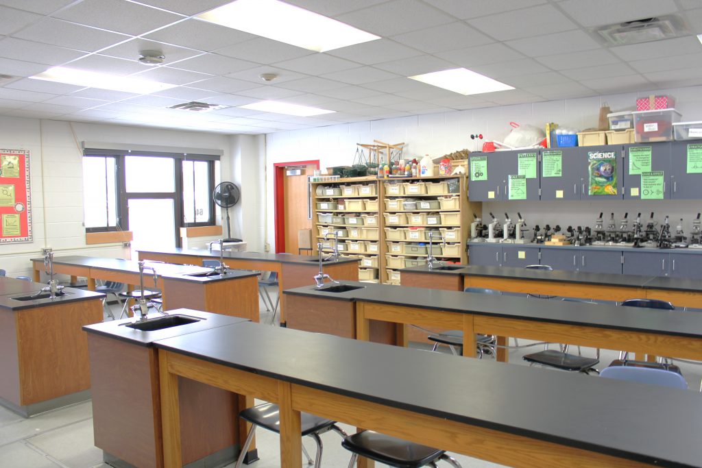 Lab room with microscopes and wash stations