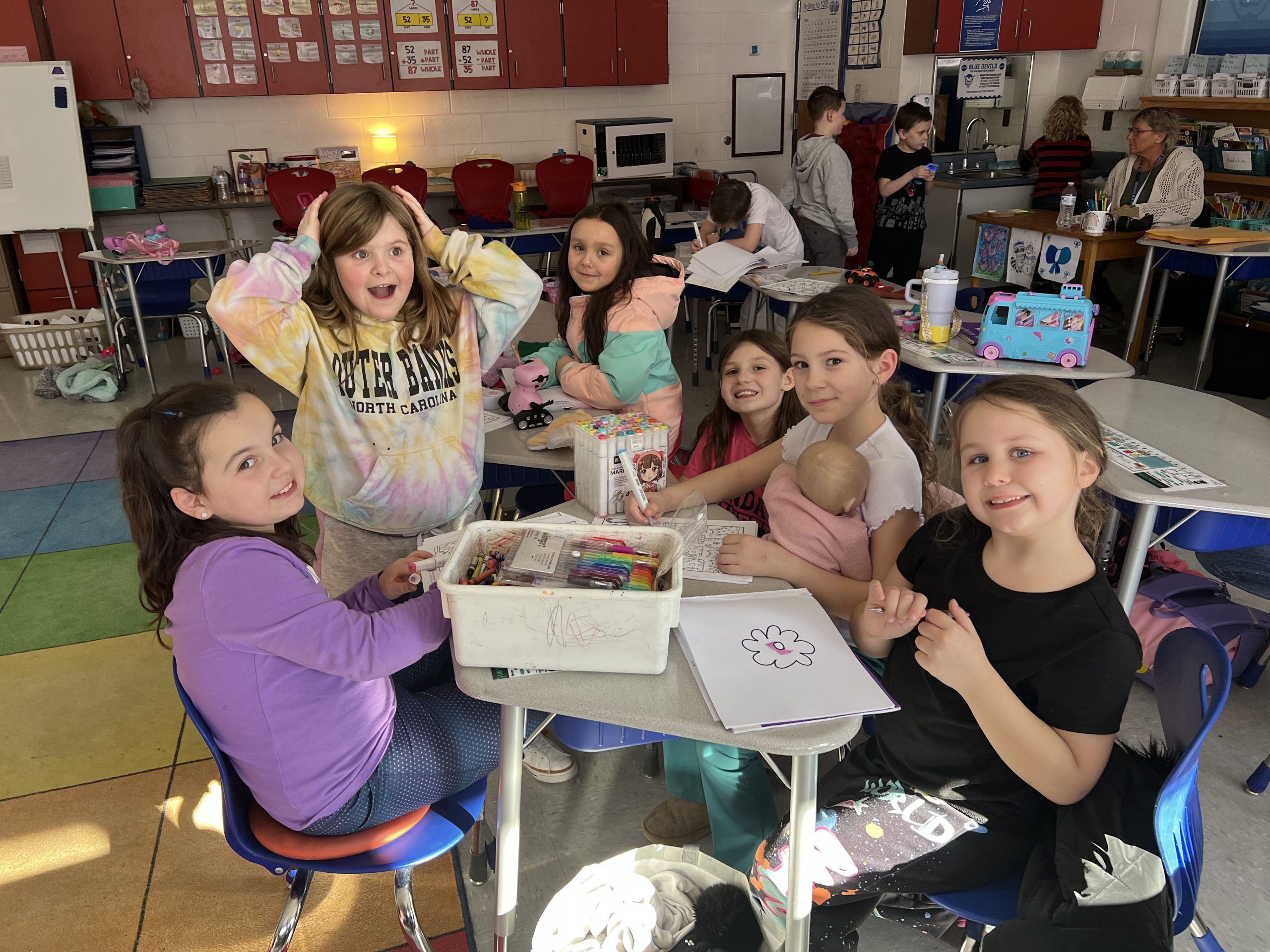 Small group of elementary females coloring and drawing