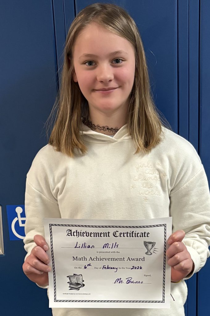 Female elementary student smiling with certificate in hand