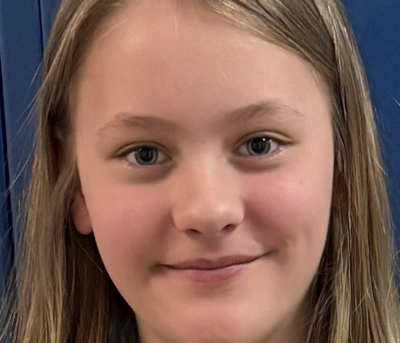 Female elementary student smiling