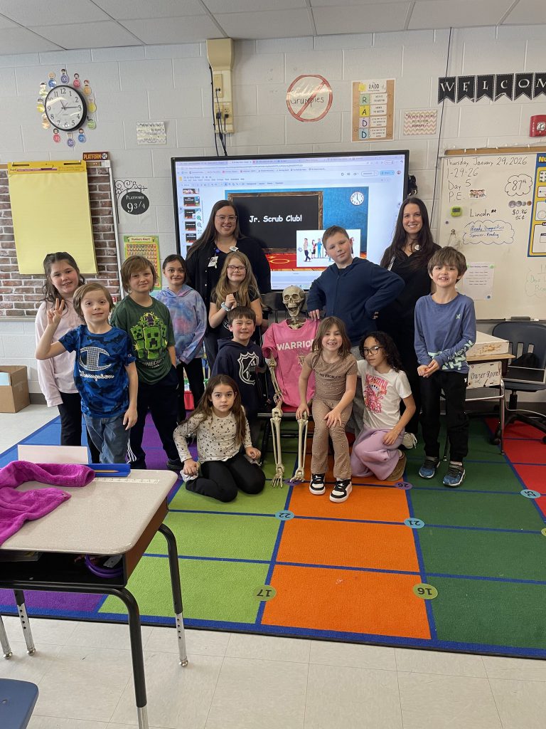 Small group of elementary students with a fake skeleton