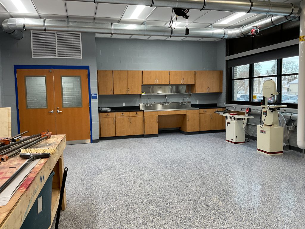 Empty classroom with electrical equipment, cabinets and sinks