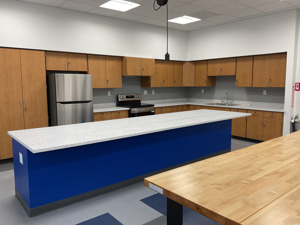 Empty classroom with large wooden desk and marbled desk