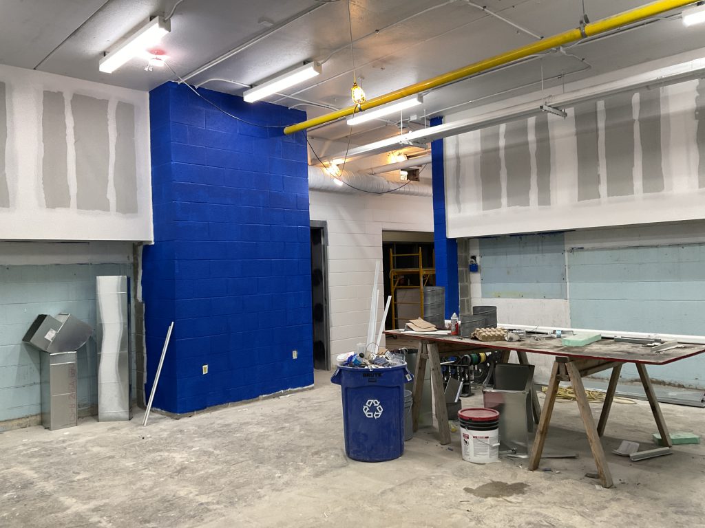 Building interior with work space and blue garbage can