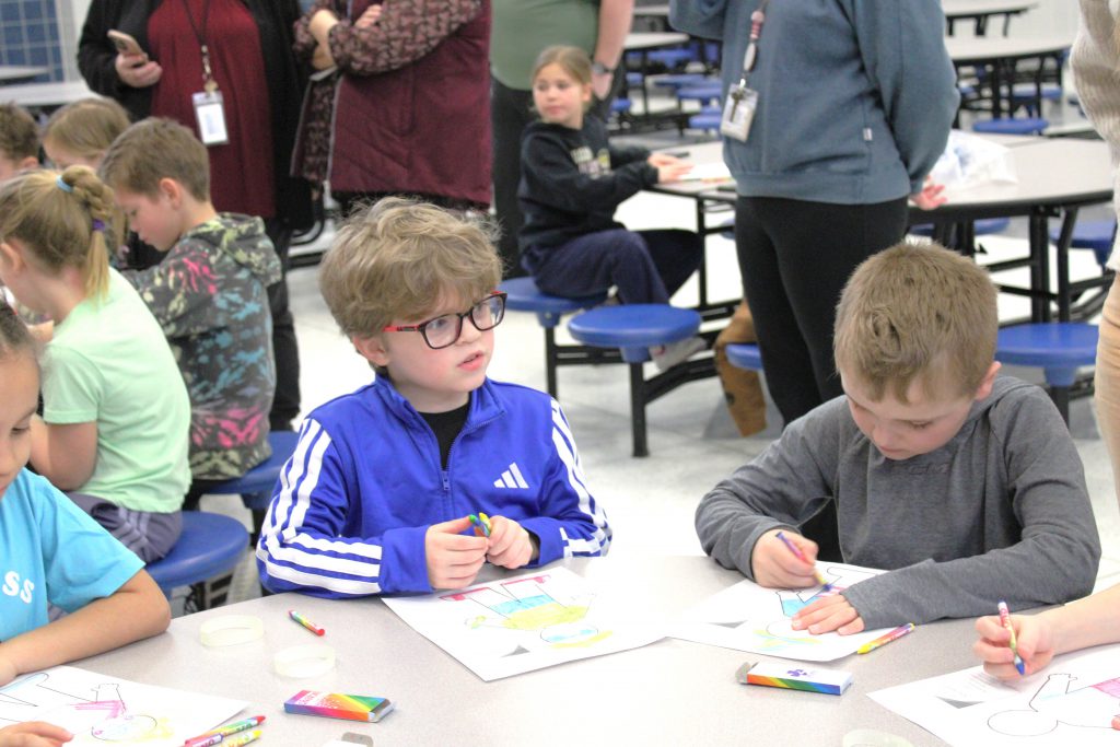 Two male elementary students coloring