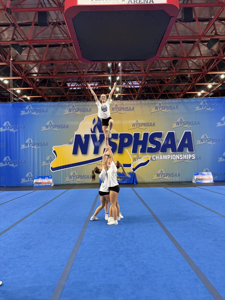 Small group of female high school cheerleaders performing at New York State Public High School Athletic Association state championships