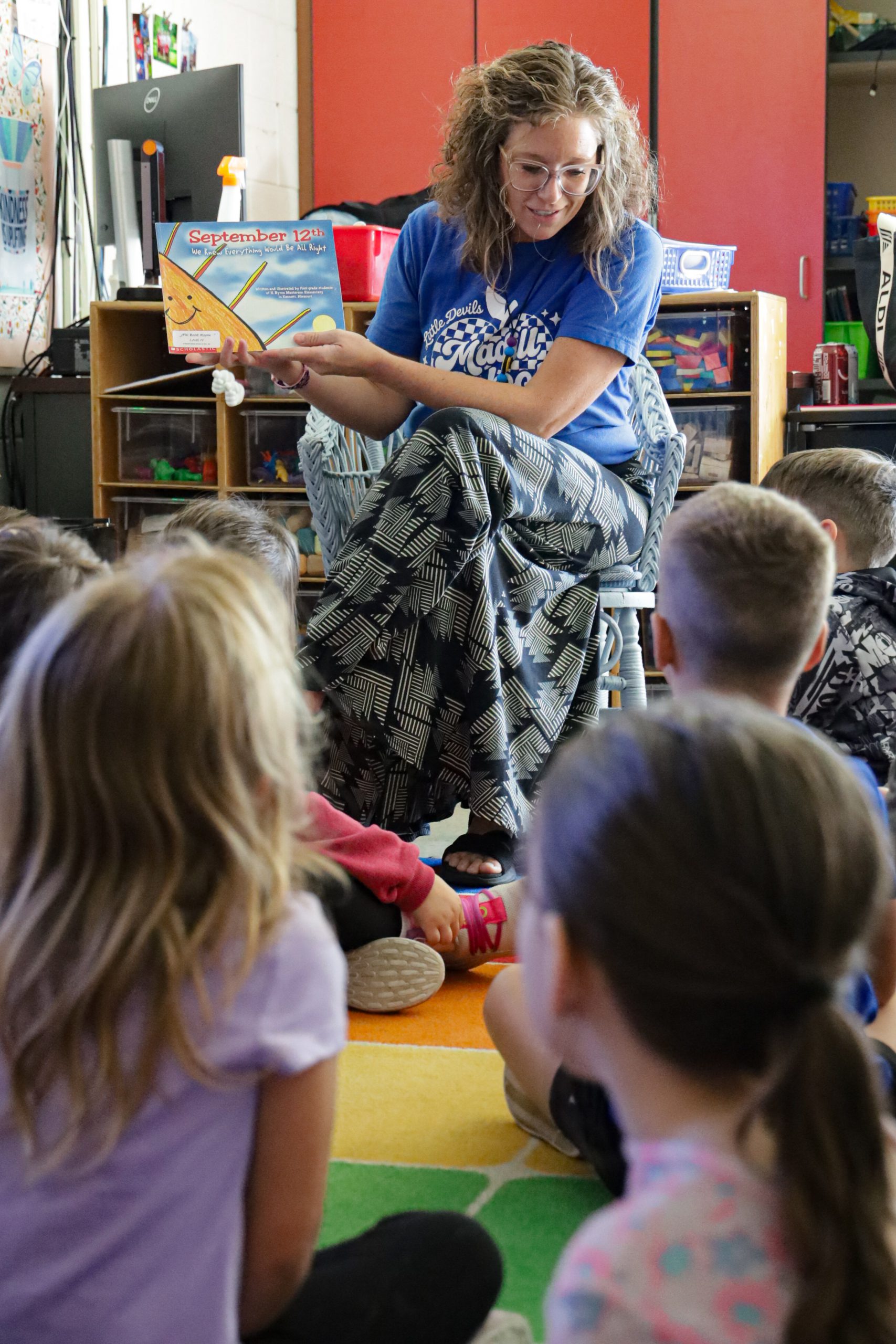 teacher reading to elementary class