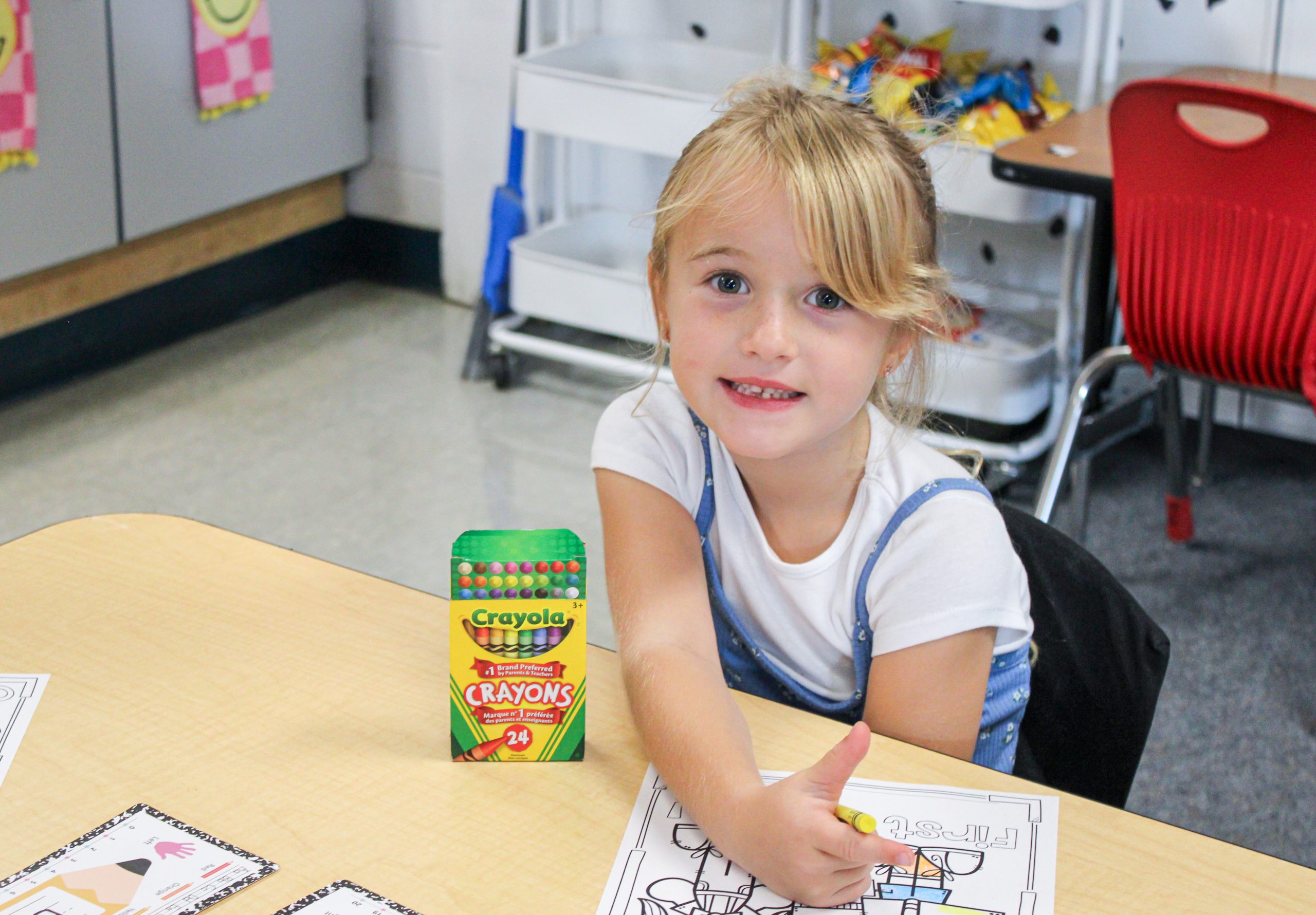 student with crayons