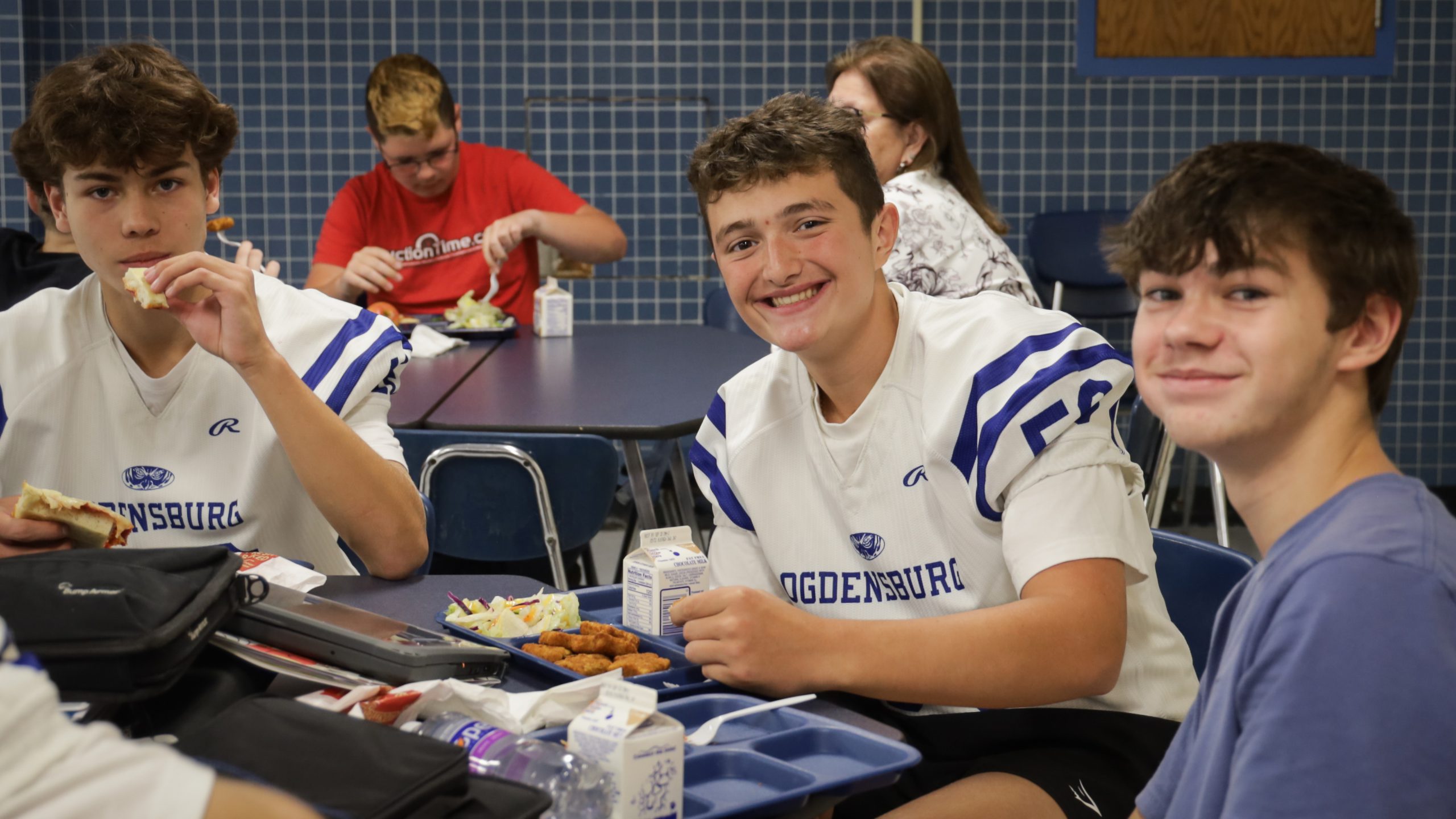Student at lunch in football jersey