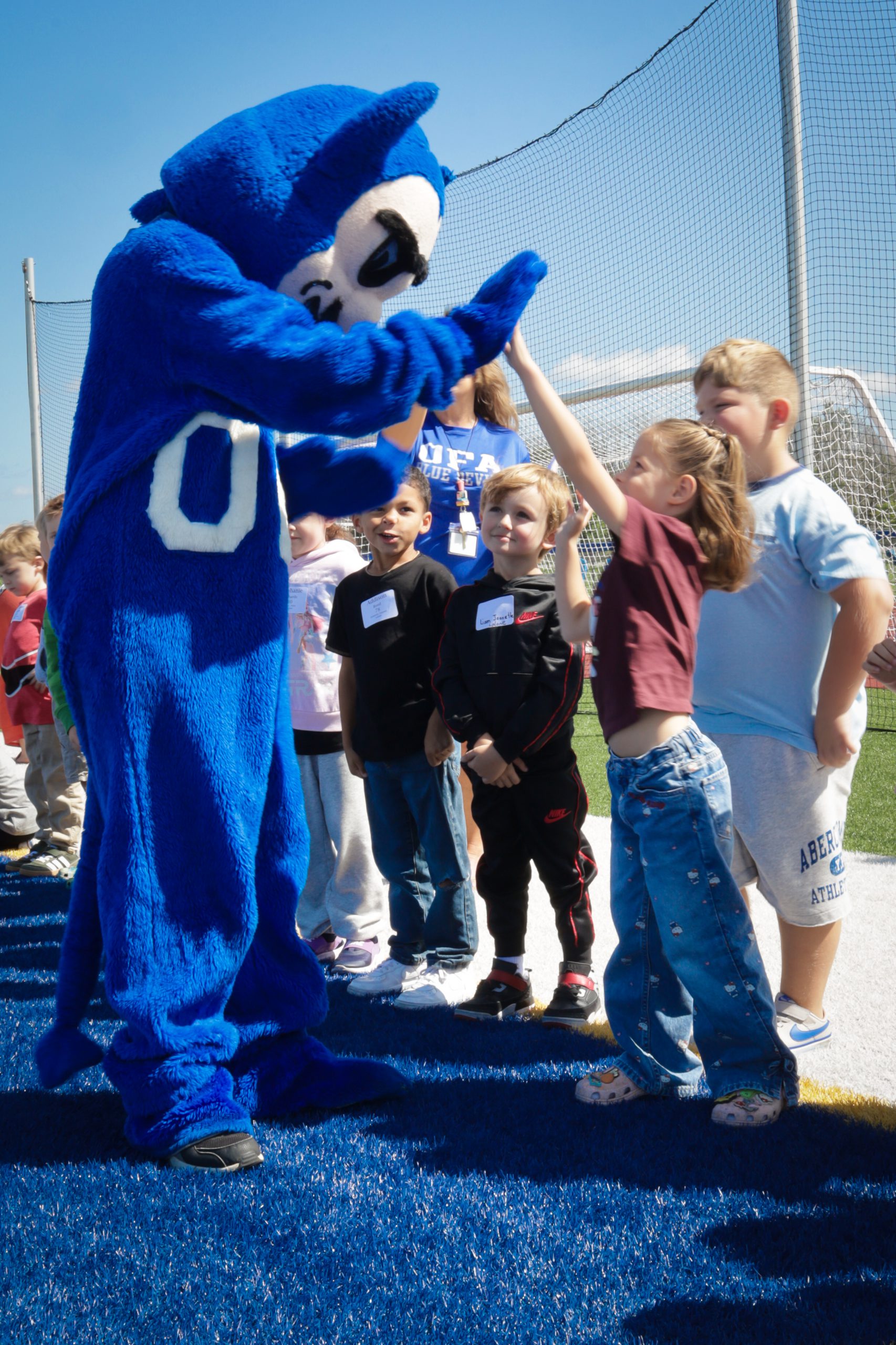 blue devil mascot high five student